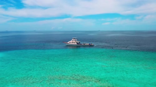 White Boat of Local Fishermen and Turquoise Sea with Coral Reef in Maldives