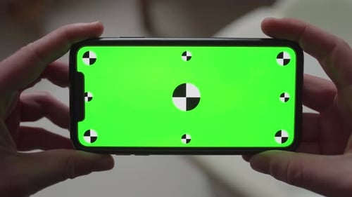Close-up of latest smartphone technology with integrated green screen