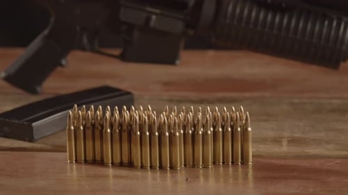 Dolly of ammunition with an out of focus AR-15 in the background