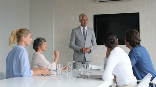 Business Team Meeting with Presentation in Office