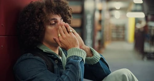Stress, sad student and man in library for test fail, headache and study fatigue in university