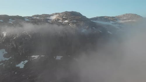 revealing the mountains from the clouds in Norway