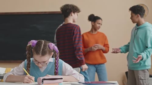 School Girl Studying in Classroom