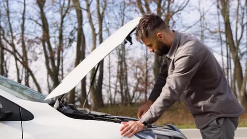 A Turkish Man Repairs the Car in the Middle of the Highway