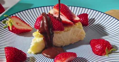 Chocolate Sauce Pouring over Strawberry Cake Slice