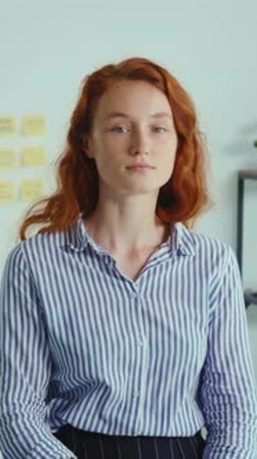 A Woman with Red Hair Showcases Her Style in Striped Shirts