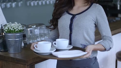 CU TU Waitress holding tray of tea cup and smiling / Breda, Noord-Brabant, Netherlands.