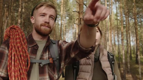 Couple Navigating with Map in Dense Forest