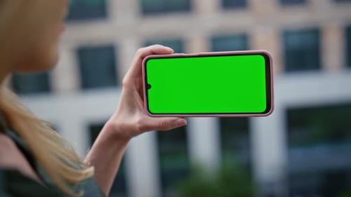 Businesswoman Finger Tapping Chroma Key Cellphone at Modern District Closeup