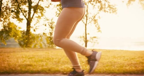 Closeup of Young Sporty Woman Runner Legs Training in Morning in Public Park Fitness Girl is Jogging