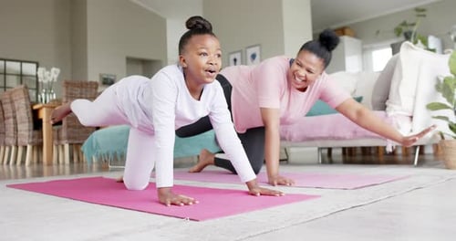 Girl and Adult Exercising Together on Yoga Mats