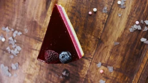Berry Cheesecake Slice on Wooden Surface