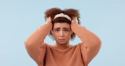 Anxiety, thinking and face of sad woman in studio with stress, mistake or disaster on blue