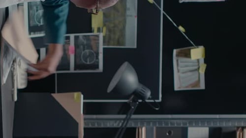 Detective Analyzes Evidence at Workplace Crime Board