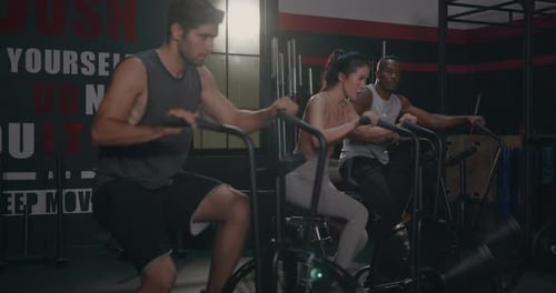 Group Fit During Cardio Cycling on Air Bike Cross Training at Gym