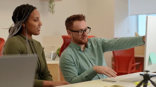 Teamwork at Computer Desk in a Modern Office