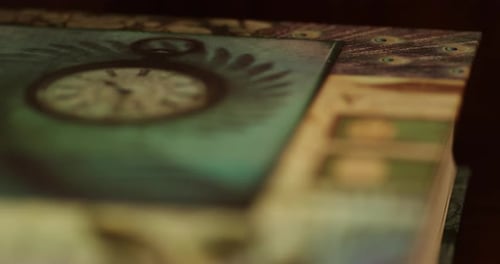 A book's cover lying on a table, close up focus pull