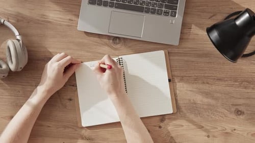 Female Hands Write with Pen Phrase LESSON 3 in Notebook Top Down View on Desktop