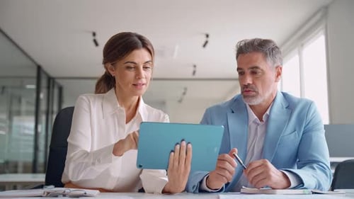 Happy Mature Female Executive Manager Holding Digital Tablet Consulting Client