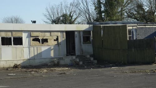 Abandoned Disused Building with Boarded Up Windows with Smashed Hole and Missing Doors