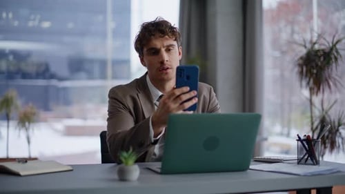Man in Suit Taking Video Call in Office
