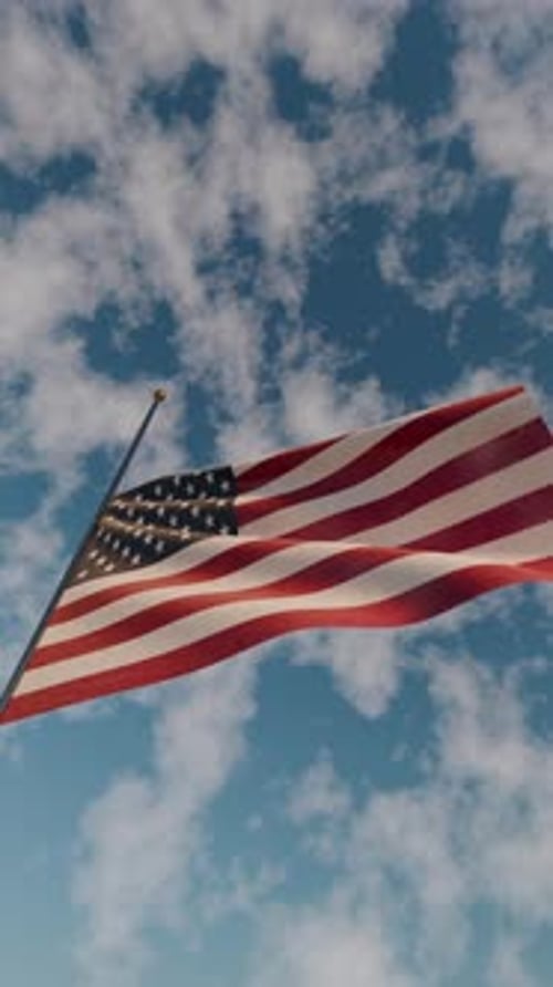 United States Flag Waving against Blue Sky and White Clouds