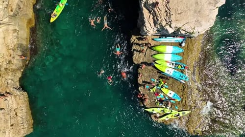 Kayaking. Sup. Aerial view of floating board and people on blue sea at sunny day.