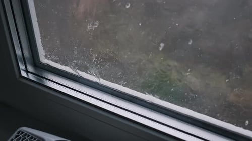 Rain Streaks Down a Window