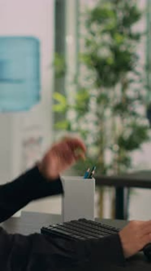 Young Woman Typing on Computer in Modern Office