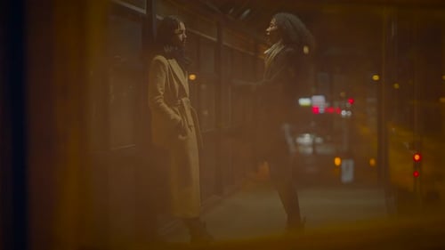 Two Young Adults Talking on City Pedestrian Bridge