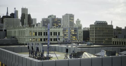 City Skyline with Rooftops and Communication Equipment at Sunset