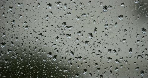 Rain dropping on glass windows
