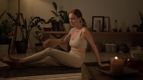 Woman Doing Yoga at Home at Night