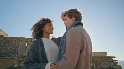 Loving Couple Embrace on Rocky Coastline