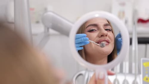 A Patient Smiles During a Dental Examination in a Modern Clinic