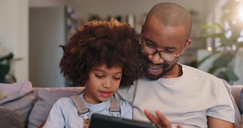 Father, son and high five with tablet, couch and happy in lounge, games