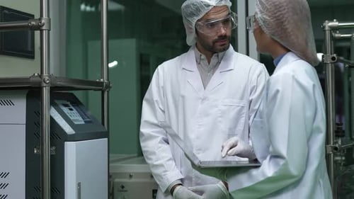 Two Scientist in Professional Uniform Working in Curative Laboratory