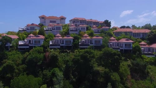 Flying over beautiful resort, Hotels suites in resort by the water, drone flying over resort.