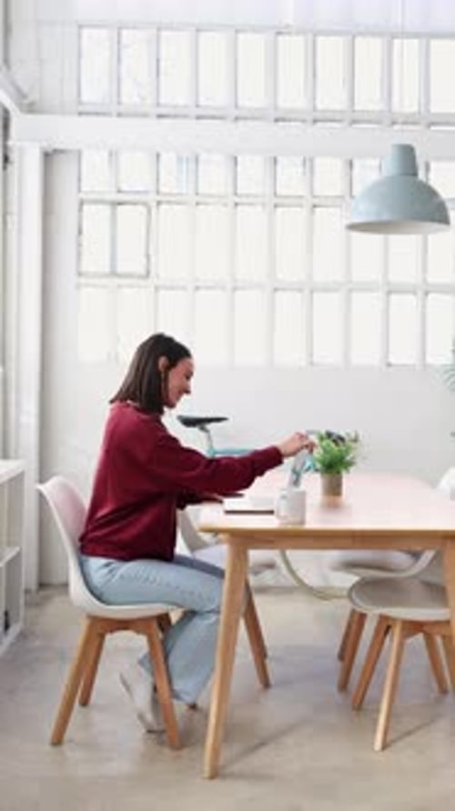 Young Professional Woman Working From Home Office with Digital Tablet and Documents