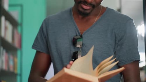 Close Up Man Smiling Reading Book With Bright Light Behind