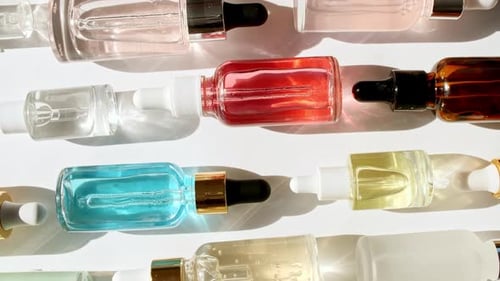 Cosmetic Oil Bottles on a White Surface