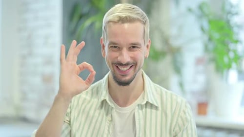 Man Smiling and Giving OK Sign