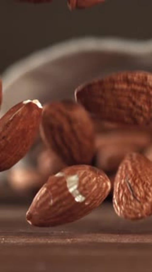 Almonds Fall on a Wooden Table Filmed on a Highspeed Camera at 1000 Fps