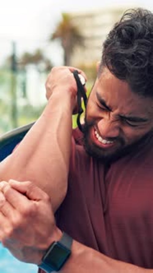 Fitness, exercise and man on tennis court with elbow pain, injury or accident with inflammation