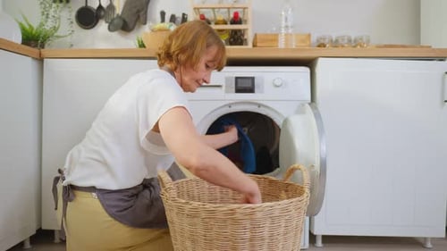 Woman Does Laundry in a Bright Kitchen