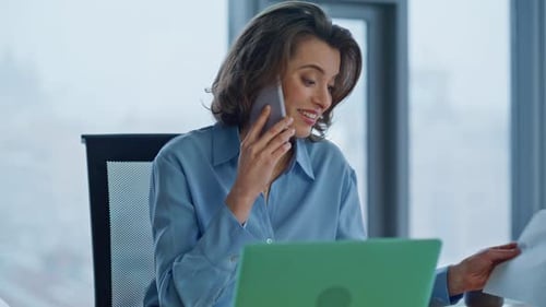 Woman Working At Desk, Talking on Phone