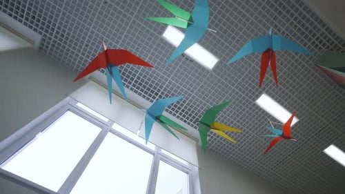 Colorful Origami Birds Hanging in School Hallway
