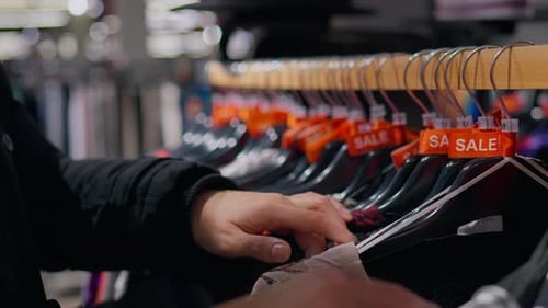 Browsing Clothes on Sale at Department Store