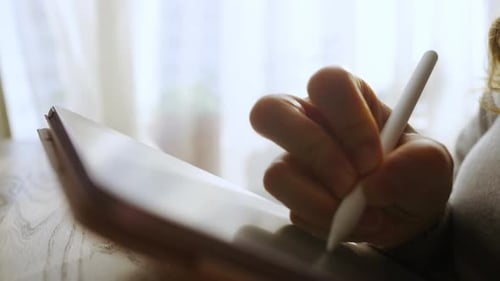 Woman Designer Drawing on Tablet with Stylus in Home Office