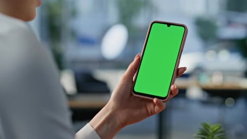 Woman's Hand Holds Smartphone with Green Screen